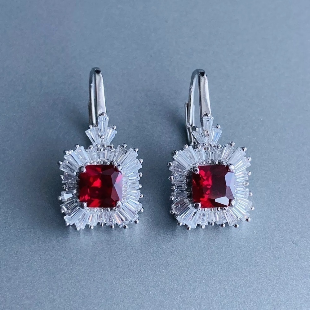 Radiant Sterling Silver Earrings with simulated ruby surrounded by CZ diamonds.